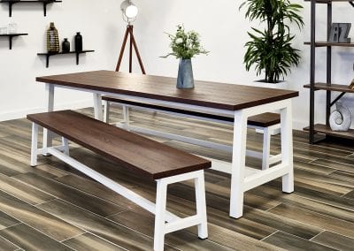 Breakout or dining room large dark wood topped bench table with white legs and matching bench seating
