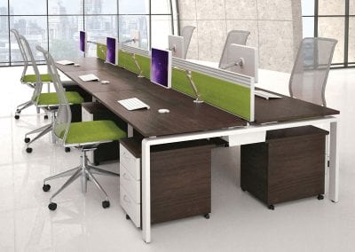 Dark wood effect back to back bench desks, integrated cable management, divider screens, 3 drawer under desk pedestal units, desk mounted monitor stands and mesh back operator chairs