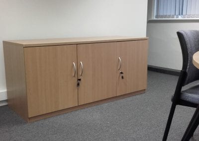 Bespoke desk height wood effect storage cupboard with 3 lockable doors