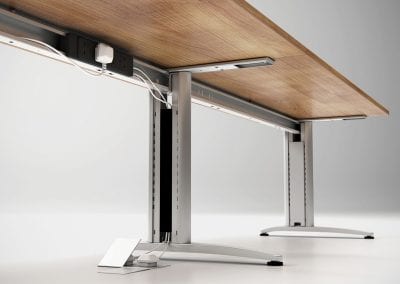 Photograph showing the underneath of beam desks and the cable management legs, trays and power supply option