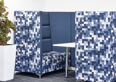 Rectangular meeting or dining pod in funky blue and white random squares pattern fabric, integrated table and chrome feet and table leg