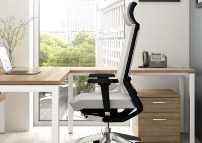 Designer executive chair with clean lines, chrome wheeled base, adjustable arms, headrest, complimentary designer desk and 2 drawer pedestable unit