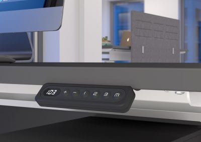 Close up detail of the control button on an electric sit or stand desk unit
