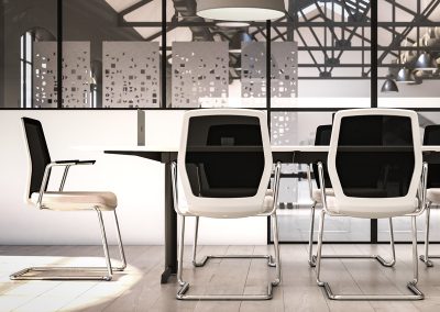 White boardroom chairs with black mesh backs and chrome frames around a white and black boardroom table