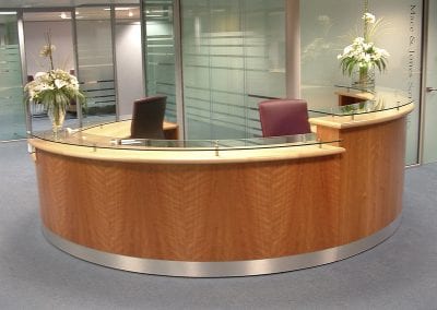 Impressive circular reception desk with raised glass customer counters and swivel chairs