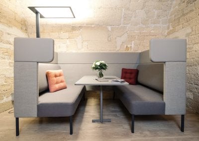 Rectangular meeting pod with sofa seating, high backs and integrated table