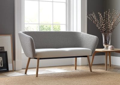 Two tone grey sofa with natural wood legs and matching natural wood coffee table