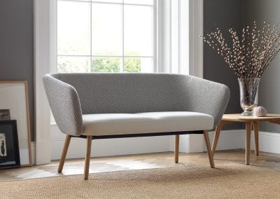 Two tone grey sofa with natural wood legs and matching natural wood coffee table