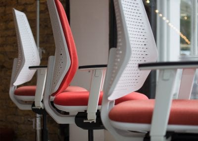 White boardroom chairs with arms, swivel bases and optional cushioned backrests
