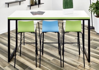 Photograph of three stools around a white topped table