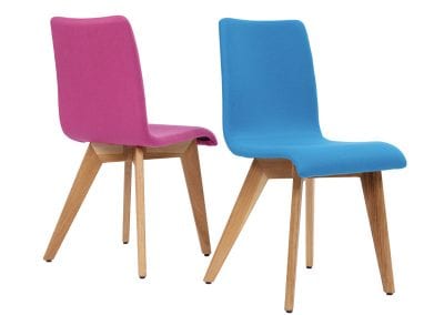 Pink and blue fabric covered occasional seats with natural wood legs for reception areas