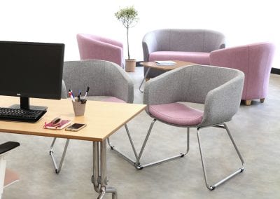 Grey and pink fabric occasional seats with chrome legs, matching tub chairs and sofa, tilt top meeting table and complimentary coffee table