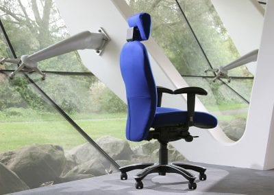 Side rear view photograph of an executive adjustable high back posture chair with arm and head rests