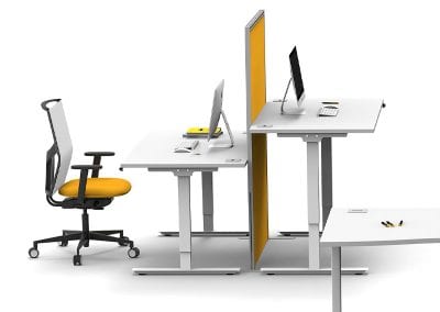 White sit or stand height adjustable desks with cable ports and floorstanding divider screen and fully adjustable operators chair