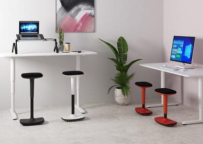 Photograph of four Rockit stools at two white tables with computers on them