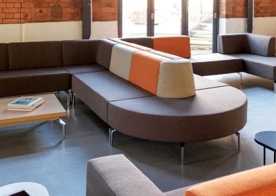 Modular soft seating sofa with straight, corner and d-shape end sections with low backs and metal feet