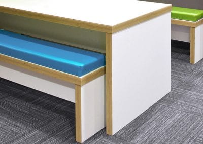 White bench tables and matching benches with wood effect edging and funky colour seating pads