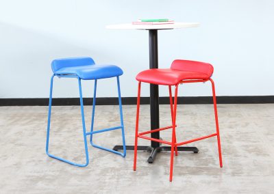 Photograph of two Ultra Summit Cafe stools, one red, one blue next to a tall cafe table