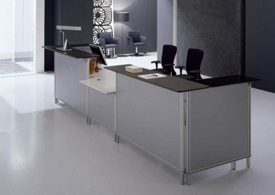 Grey panel reception desk unit with white desktops, black counter tops and fully adjustable operator chairs