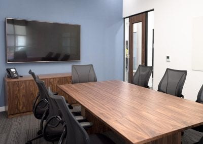 Retangular dark wood veneer boardroom table with mesh backed boardroom chairs and matching wood veneer Credenza