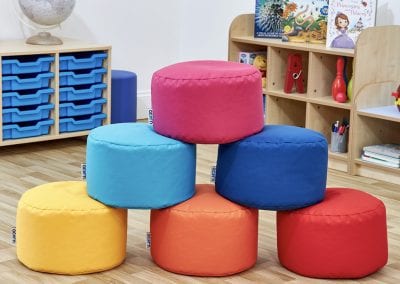 Early Years Nursery furniture including mobile tray storage cabinet, display shelves and round bean bags