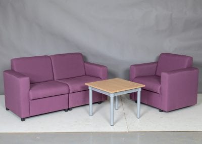 Modular sofa and chairs for staff rooms in pink upholstery with coffee table
