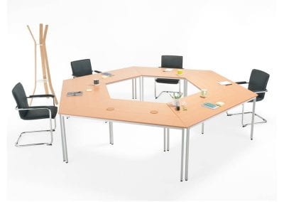 Modular angled tables shown here in a hexagon shaped meeting table configuration with black leather meeting chairs
