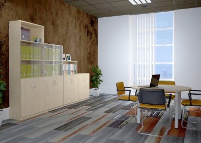 Wood veneer storage cabinets in various heights, some with glass doors and shelving, positioned in a room with a circular meeting table and meeting chairs with arms