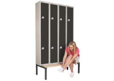 Personal effects lockers mounted on a metal framed bench seat with wood slats for changing rooms