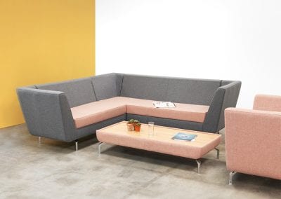 Modular staff room sofa, chair and coffee table in grey and pink fabric with chrome feet