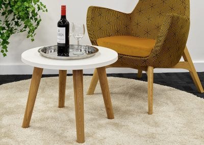 White top coffee table with wooden legs and funky fabric occasional chair with matching wooden legs