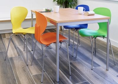 Rectangular wood veneer meeting table with metal legs and stylish multi coloured stacking meeting chairs
