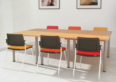 Rectangular wood veneer meeting tables with round metal legs and meeting chairs with different colour fabric seat and back pads