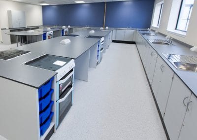 Fully fitted bespoke catering and kitchen training room with sinks, ovens, storage cupboards, tray storage and electric ports