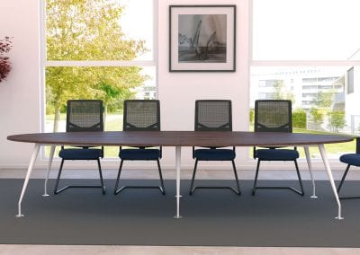 Large oval dark wood veneer meeting table with white legs, surrounded by black mesh backed meeting chairs.