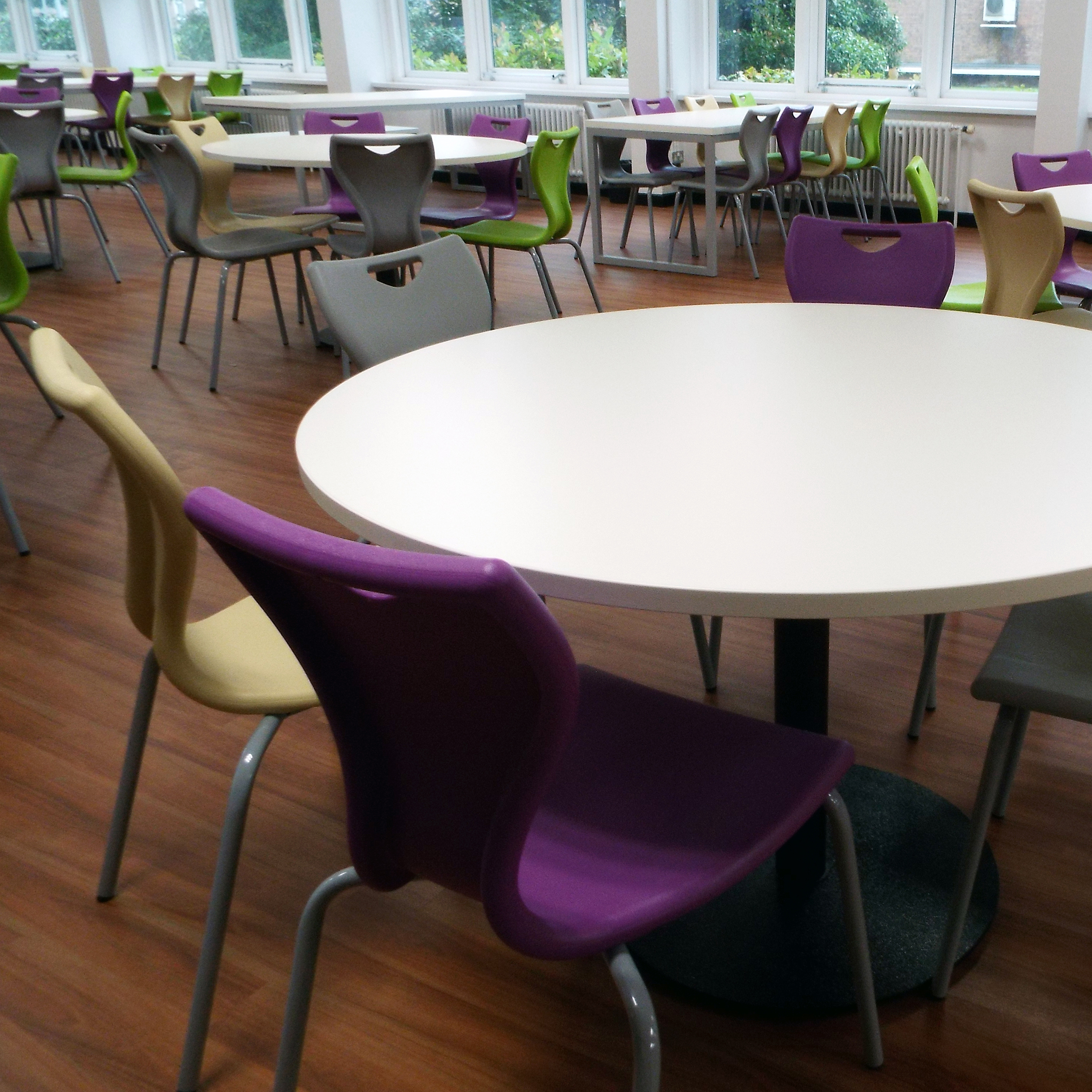 Tick Solution Dining and Refectory Fade In Photograph of three Rockit stools set at different heights, one red, one black and one white