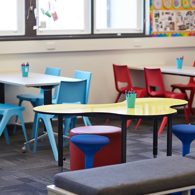 Tick Solutions Education Tables Fade In Photograph of three Rockit stools set at different heights, one red, one black and one white