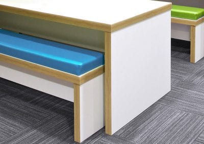 White and wood bench table and bench seats with different colour seat pads