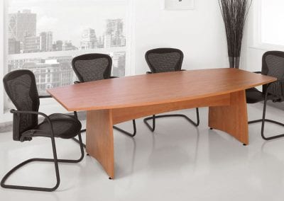 Wood barrel shaped meeting table with black mesh backed meeting chairs