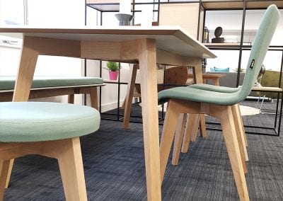 White topped rectangular bench table with wooden legs and matching seating