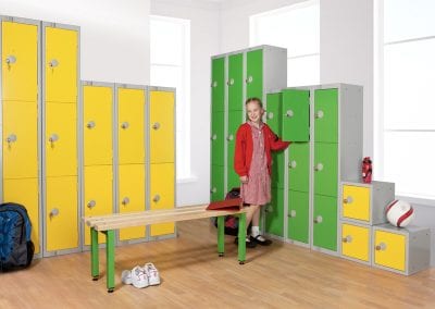 Various size personal effects lockers with yellow and green doors, with a matching changing bench