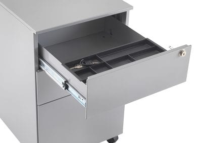 Close up of an open pedestal drawer with key lock and internal sliding storage compartment
