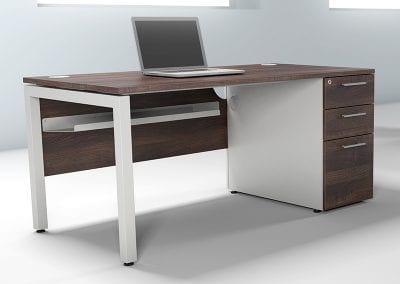 Designer pedestal desk with dark wood veneer desk and drawer fronts, with white legs and cable management tray