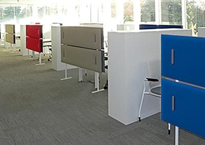 Freestanding coloured acoustic screens in an open plan office environment