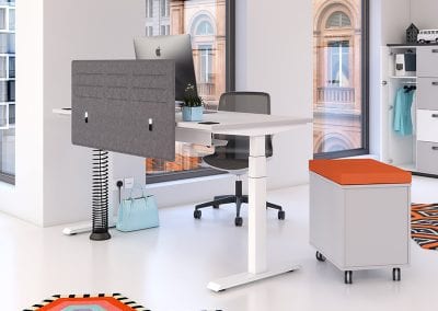 Modern designer desktop screen attached to a white electrical height adjustable desk