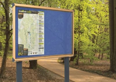 Outdoor glazed noticeboard with wooden frame and metal legs