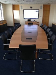 Executive boardroom meeting table with inlay veneer and integrated cable management, with black leather and chrome meeting chairs