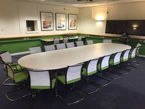 White and chrome modular meeting table with matching meeting chairs with armrests and colour coded seating pads and back rests