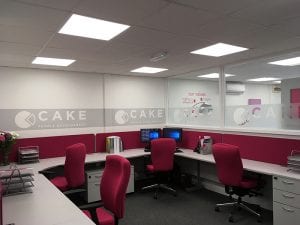 Grey bench office desks with matching pedestals and pink fabric covered operator chairs