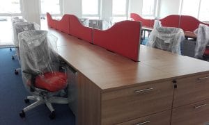 Veneer office desking with orange fabric divider screens and matching orange fabric operator chairs